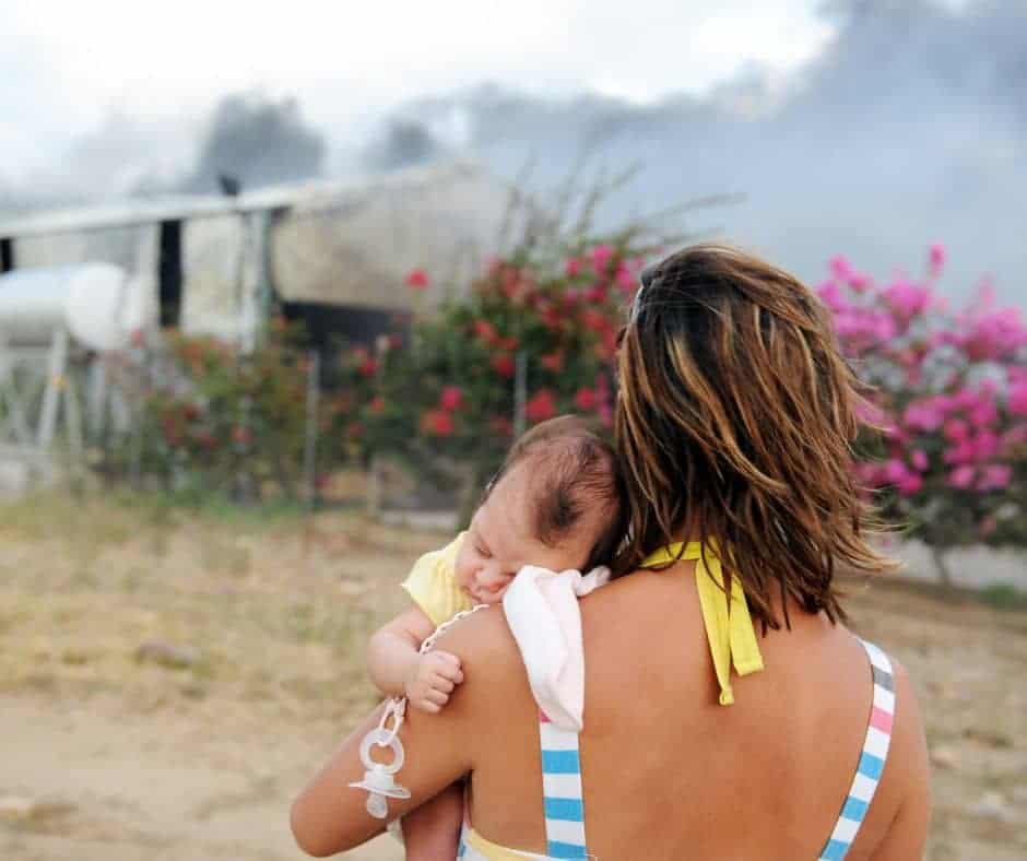 Postpartum Mom with infant watching wildfire