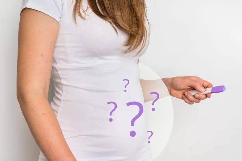 woman holding pregnancy test with images of question marks and a pregnant belly on top of her abdomen